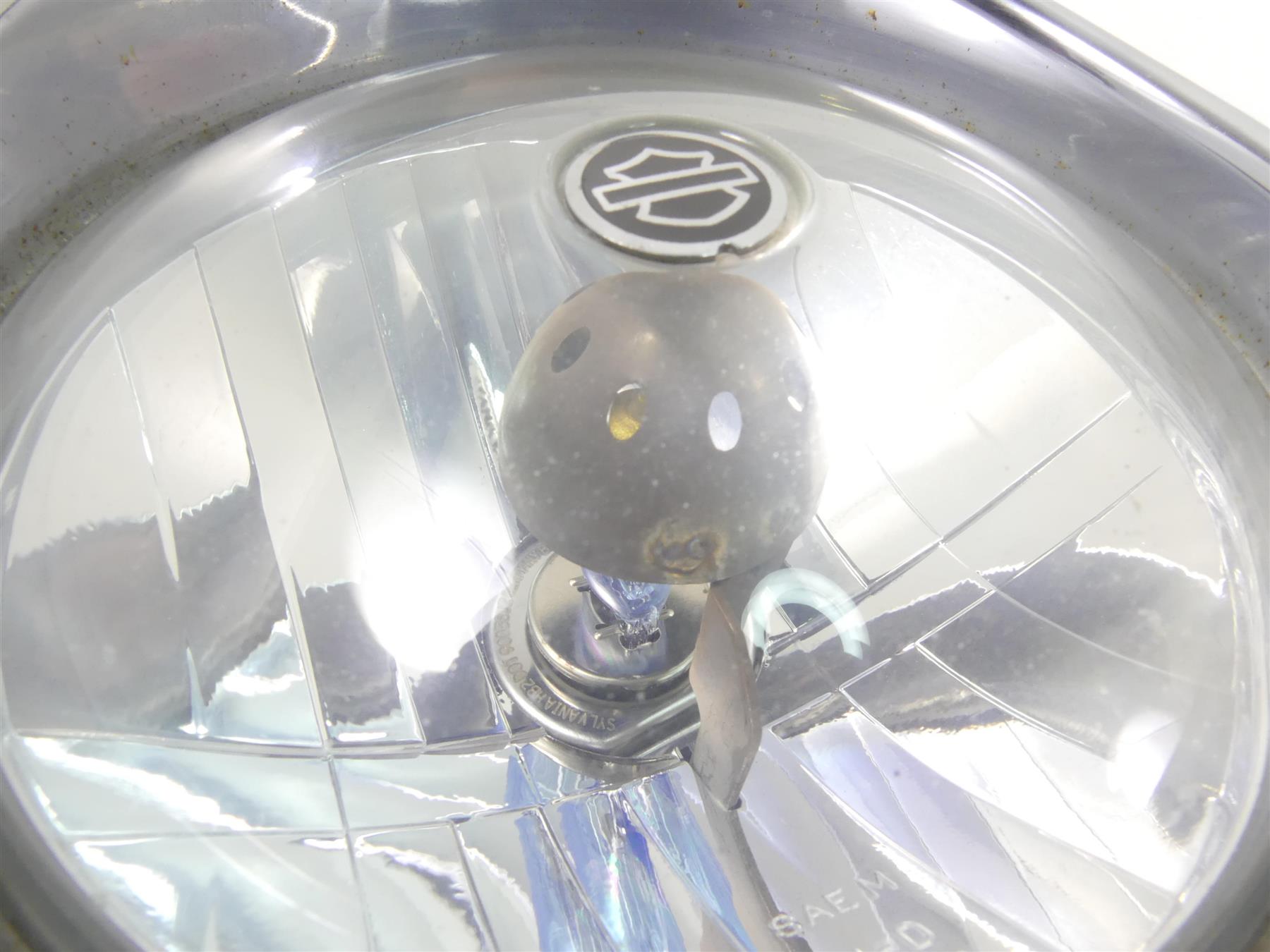 Used motorcycle headlight assembly with bulb and reflector, close-up view, available at Mototech271