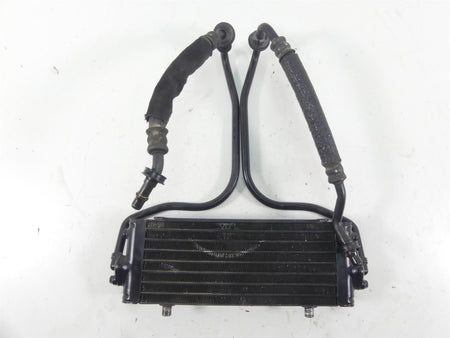 Used motorcycle oil cooler with attached hoses, black metal, available at Mototech271