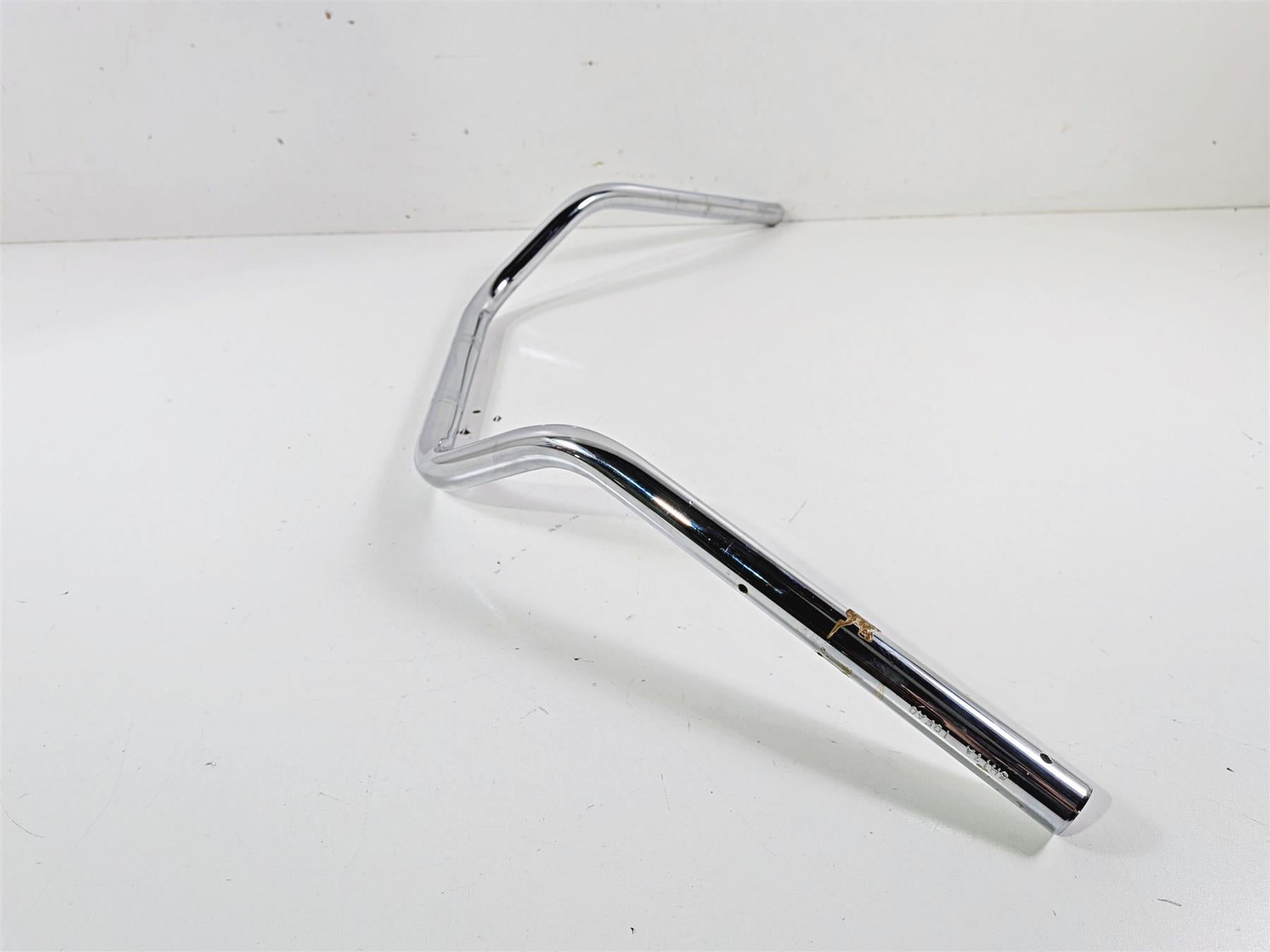 Chrome motorcycle handlebar with slight surface wear, available at Mototech271
