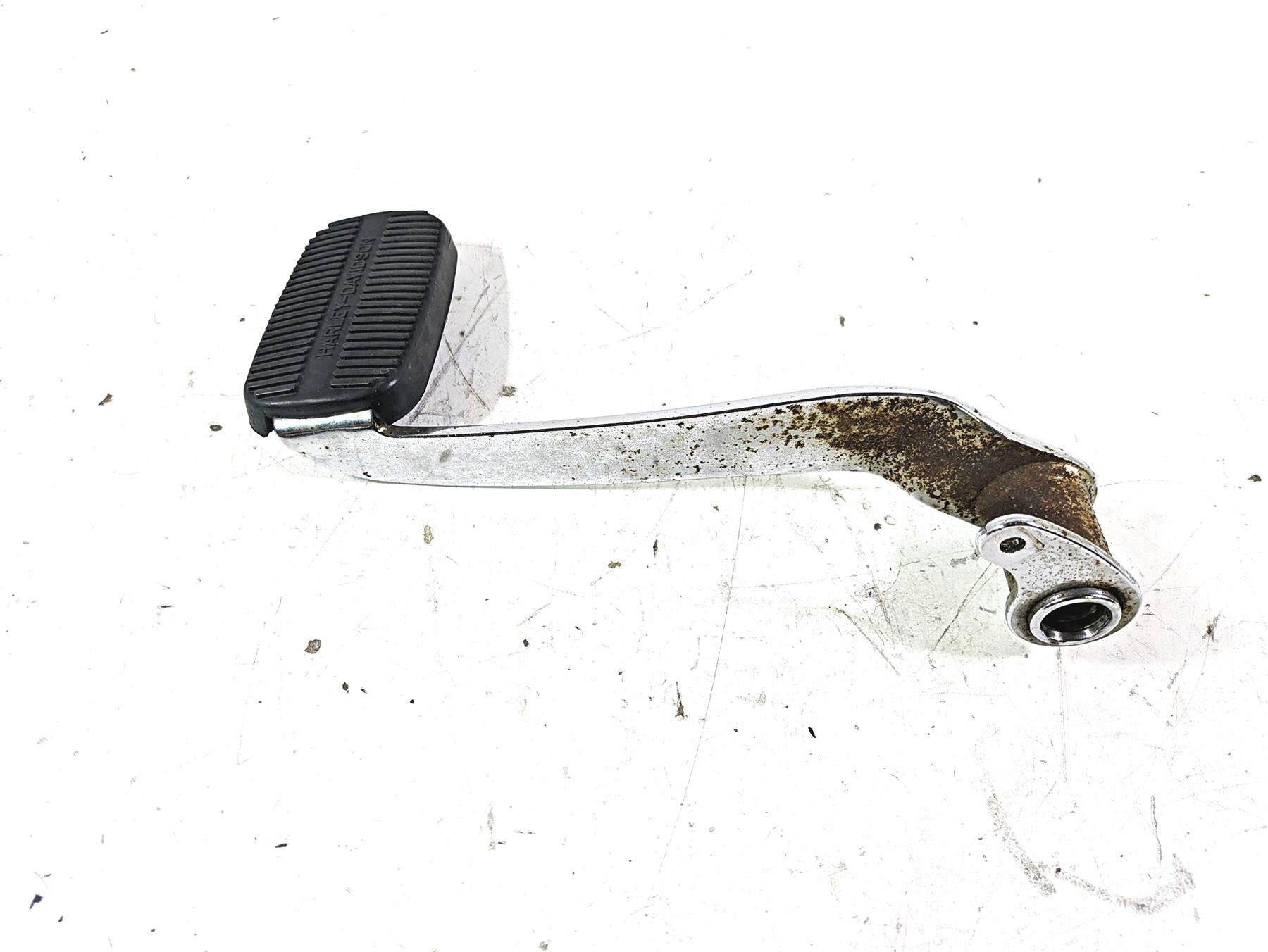 Used Harley-Davidson motorcycle brake pedal with rubber pad and rusted metal, available at Mototech271