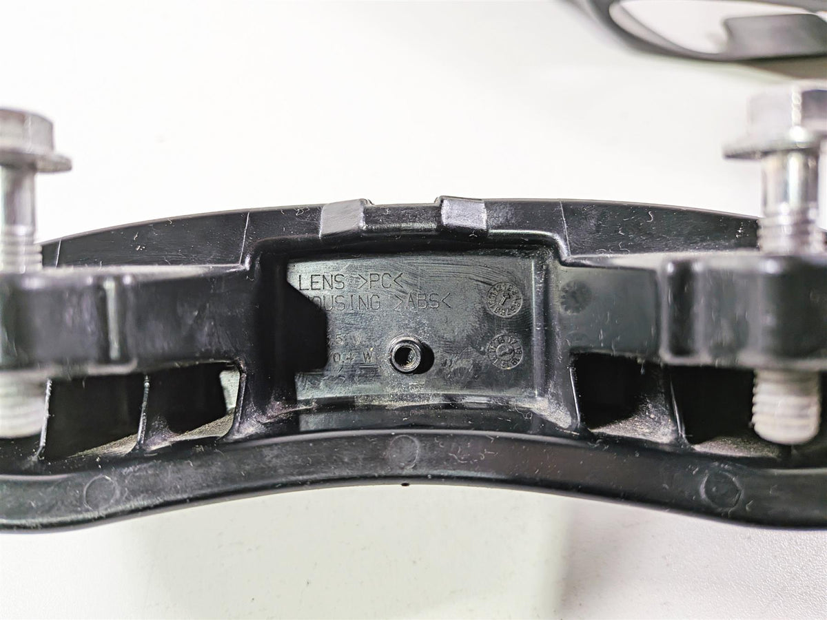 Closeup of used black motorcycle part with metal bolts, mounting bracket available at Mototech271