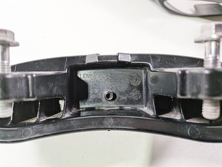 Closeup of used black motorcycle part with metal bolts, mounting bracket available at Mototech271