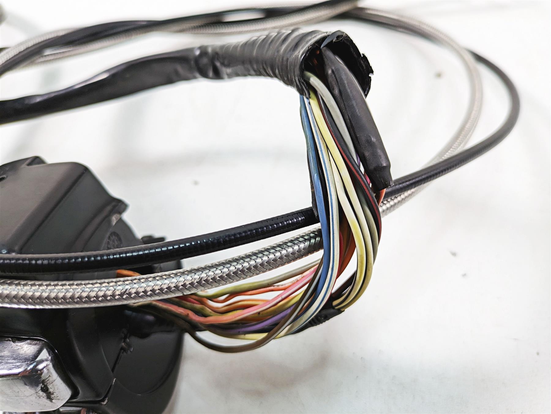 Close-up of used motorcycle handlebar wiring harness with exposed colored wires, available at Mototech271