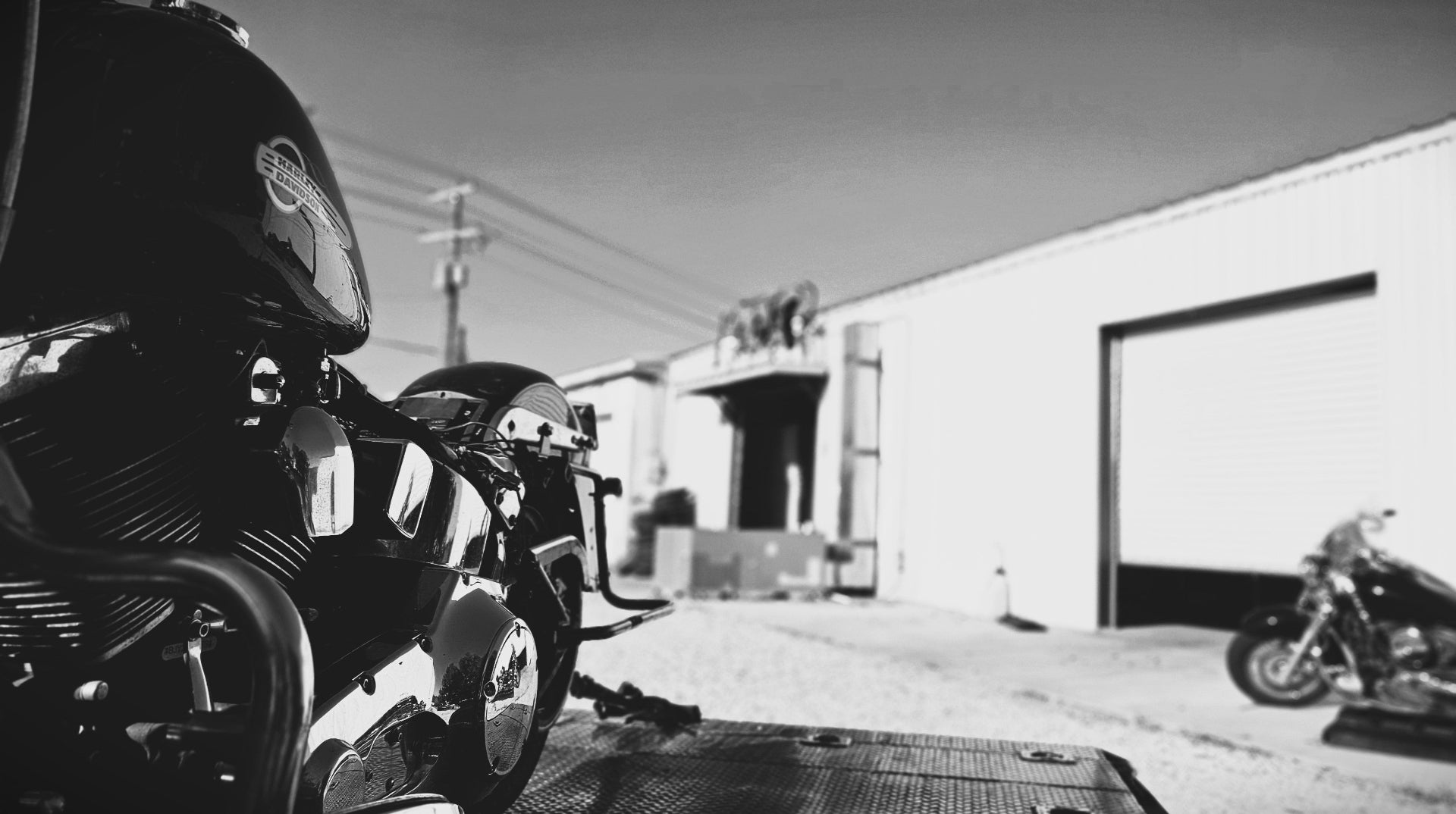 Motorcycles parked outside a building with a clear sky.