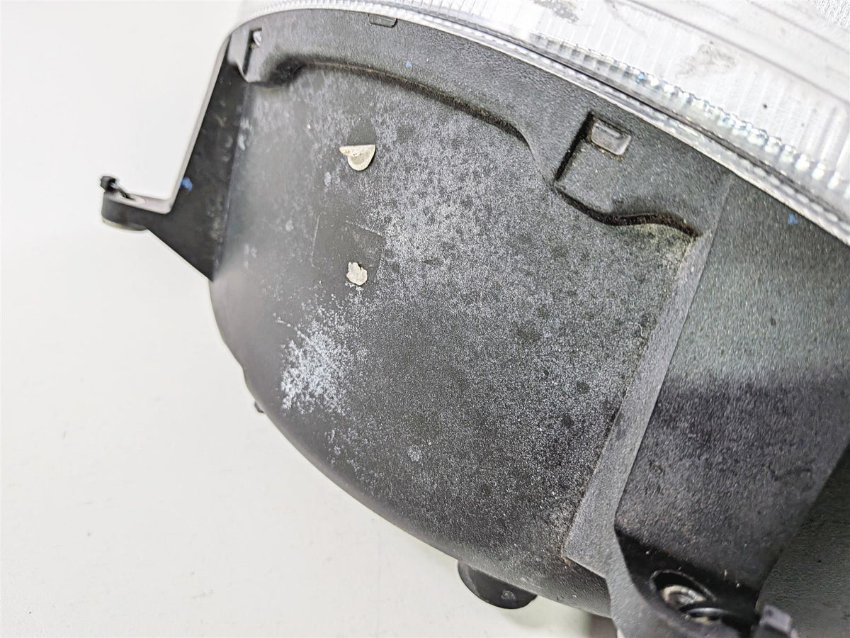 Close-up of used motorcycle headlight housing showing wear and surface scuffs